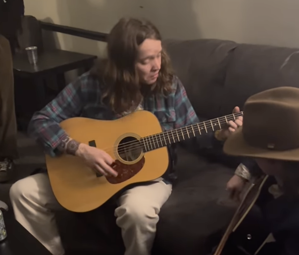 billy strings plays guitar with a child