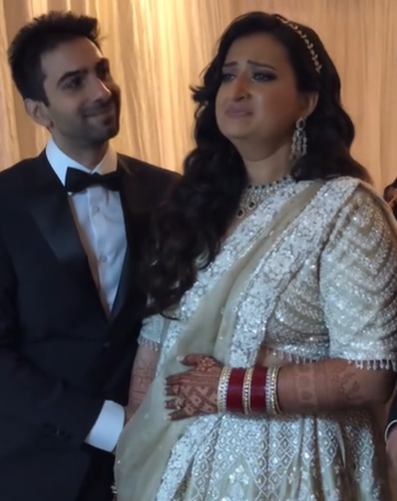 A bride is emotional when her live wedding painting is revealed.