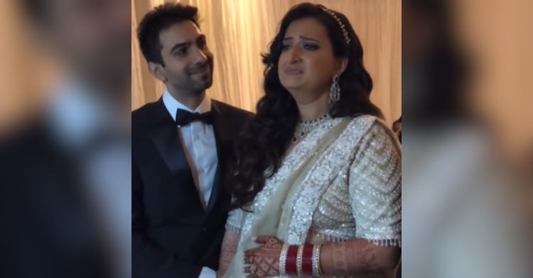 A bride is emotional when her live wedding painting is revealed.