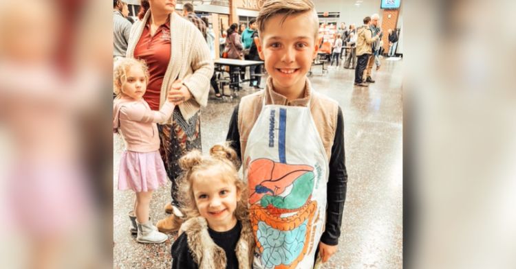 A brother and sister raising awareness at a health fair.