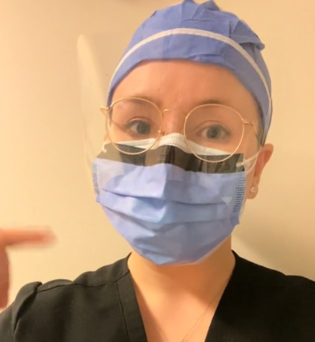 A med student with cancer wears a surgical cap and mask.