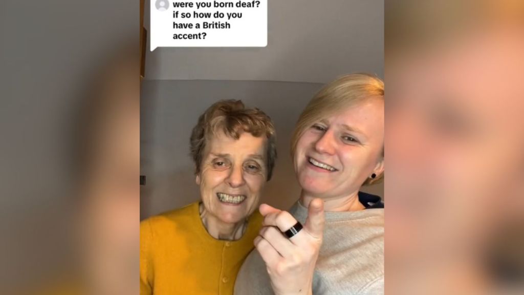 A young deaf woman stands next to her mom as they answer a question about their accent.