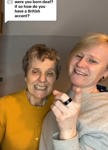 A young deaf woman stands next to her mom as they answer a question about their accent.