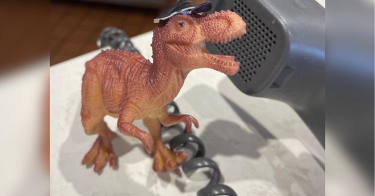 A plastic dino answers the phone at Domino's.