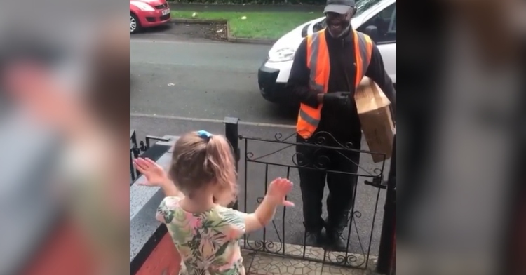 View from behind of a little girl doing sign language for her deaf delivery driver who is smiling wide.
