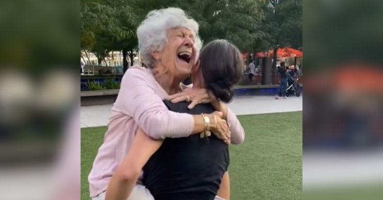 A granddaughter carries her grandma while they dance together.