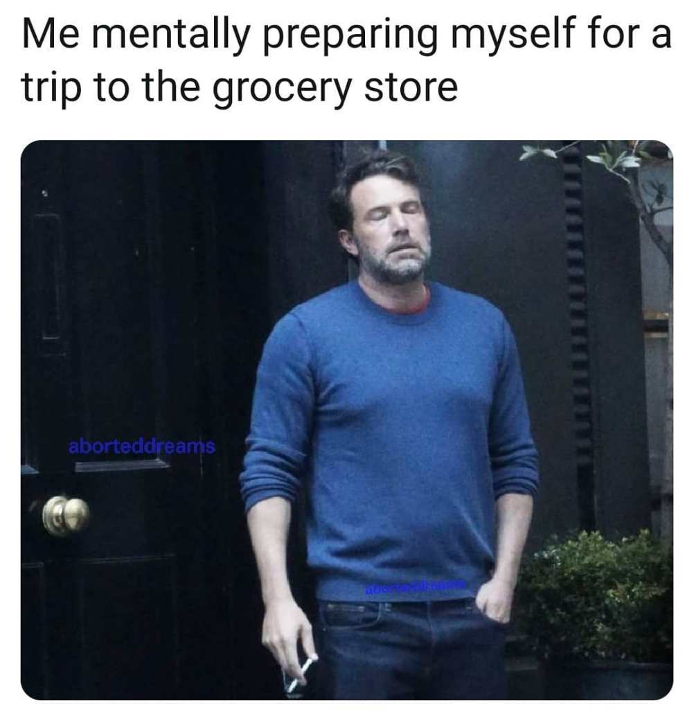 A meme with Ben Affleck standing outside smoking.
