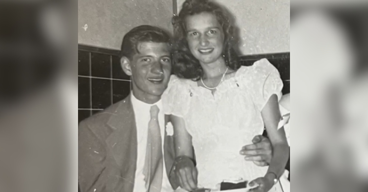 A black and white photo of a young Bill Hassinger and Joanne Blakkan. They're both smiling as she sits on his lap.