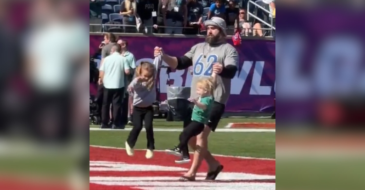 Jason Kelce lifts two of his daughters into the air with one in each hand just before the NFL Pro Bowl.