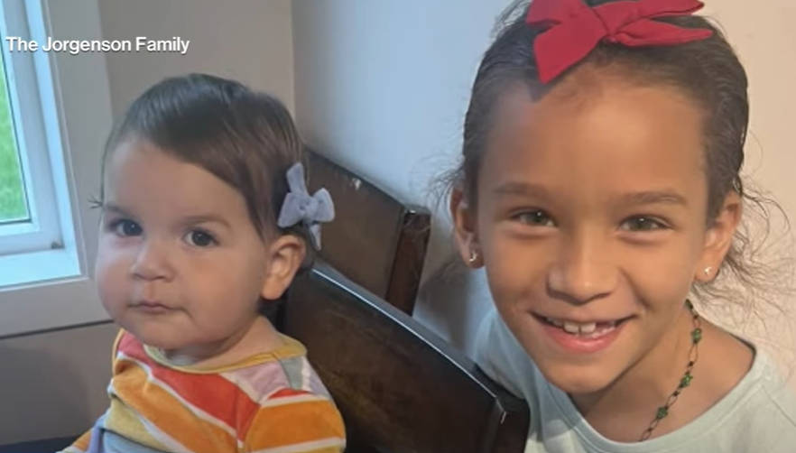 Charley and Autumn smile as they sit in chairs in their home. Charley smiles wide for the camera while Autumn gives a small smile.