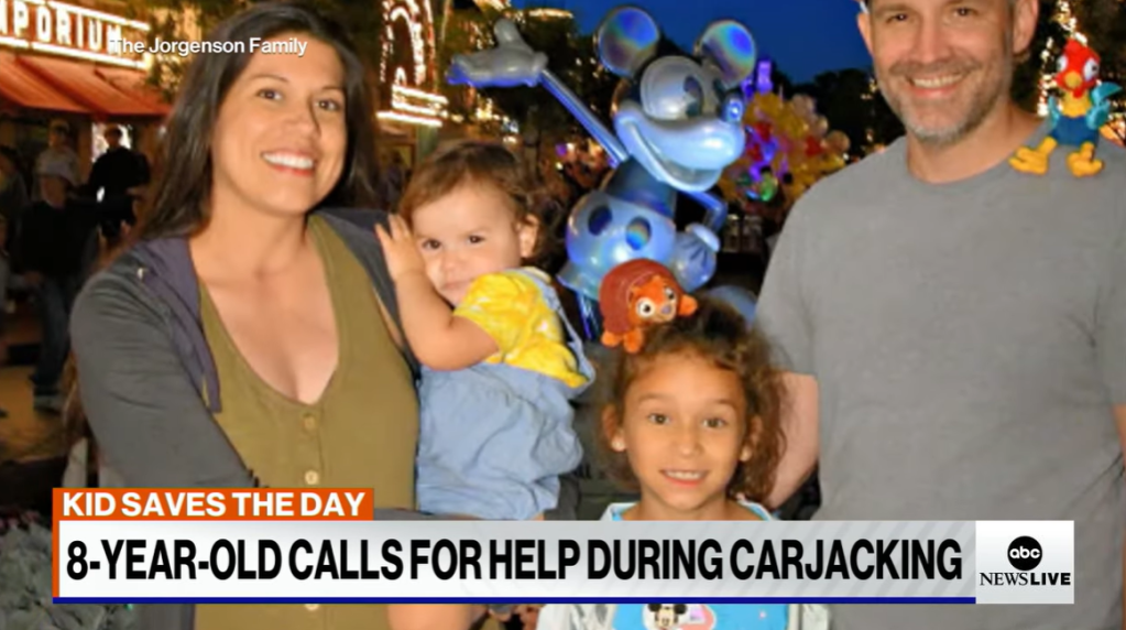 The Jorgenson family pose and smile outside at Disney. 