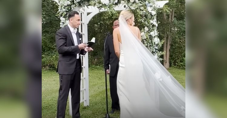 A couple is distracted by a stray kitten during their wedding.