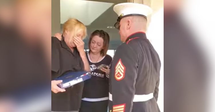 A marine speaks with the mother of a fallen officer.