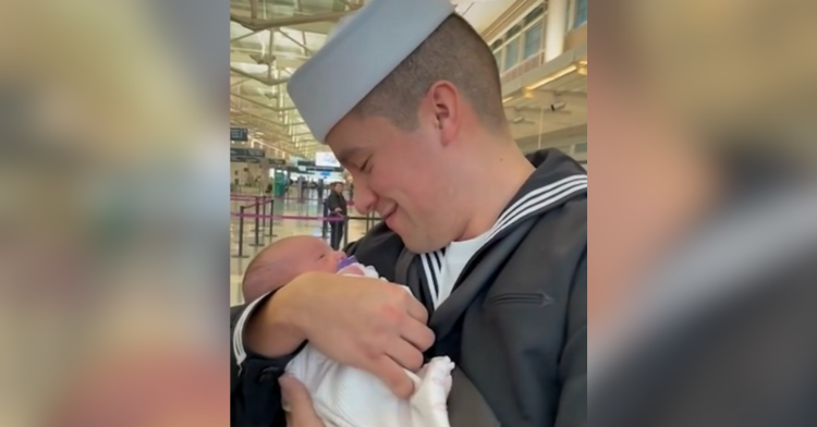 Roger Rodriguez Paez holding his newborn daughter