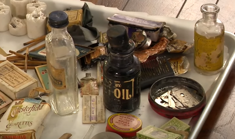 An assortment of historic cosmetic products on a tray.