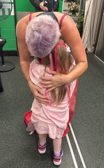Lillian and Pink embrace for a hug as they meet before her show.