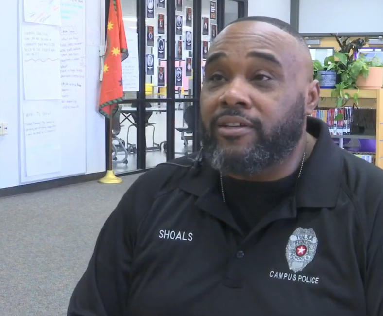 Lyndell Shoals sits in a classroom as he chats with local news.
