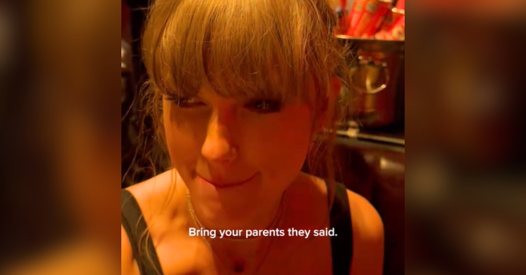 Taylor Swift purses her lips as she sits in a club. Text on the image reads: Bring your parents they said.