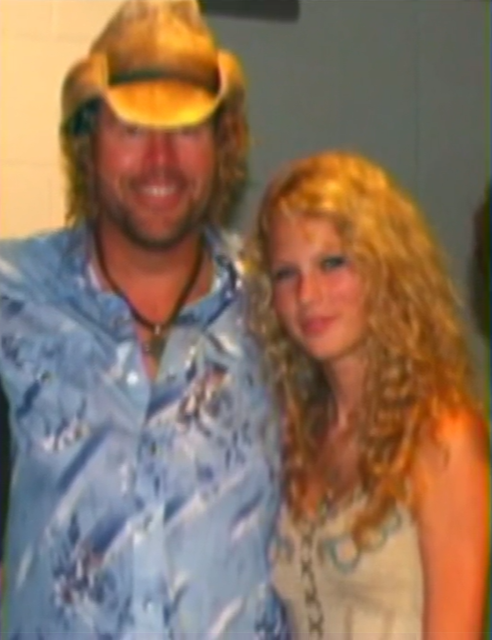 A then 15-year-old Taylor Swift smiles as she poses for a photo with Toby Keith.