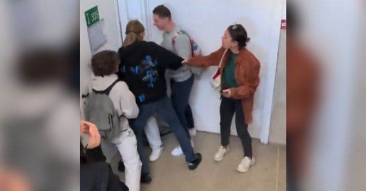 A teacher breaks up a fake fight at school.