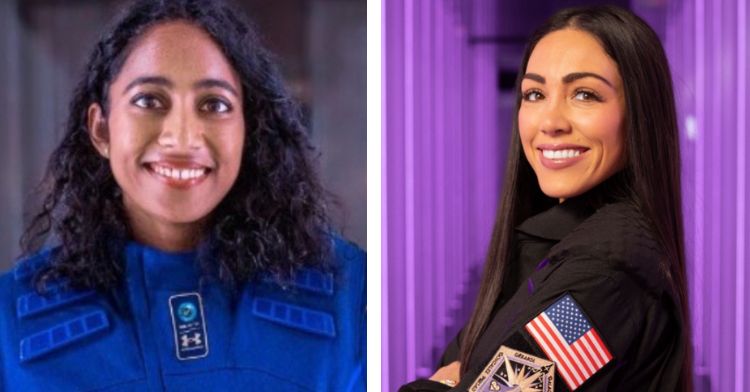 Two astronauts posing in their uniforms.