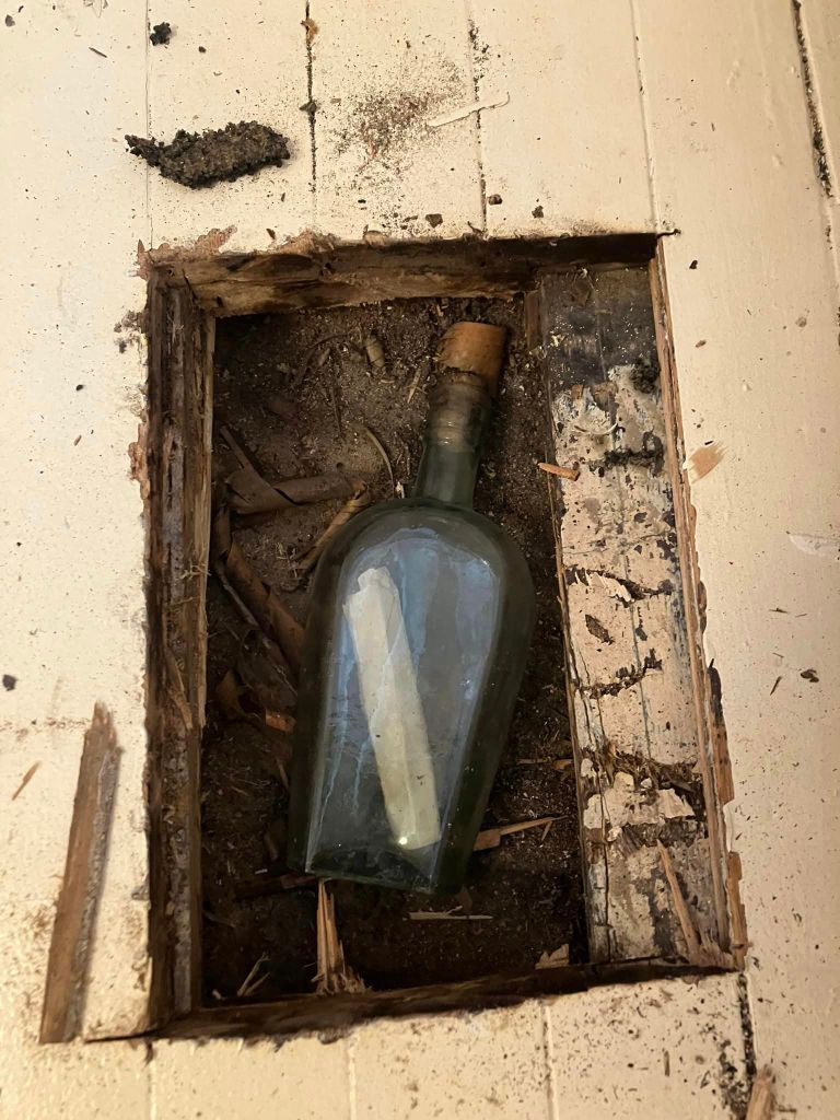An old note in a whiskey bottle under the floor. 