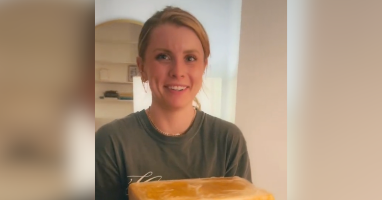 woman holding block of cheese