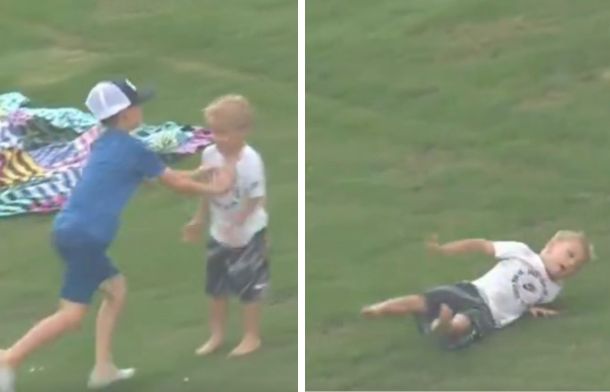 Images show the older boy pushing the younger one down during a fight the kids were having at a baseball game.
