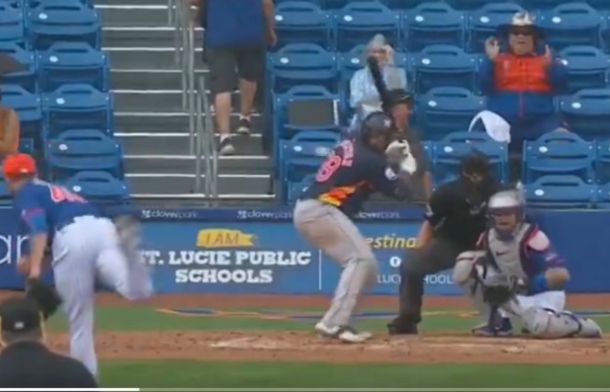 Image shows a batter poised to swing as a pitch is caught by the catchers during a Grapefruit League game between the Mets and the Astros.