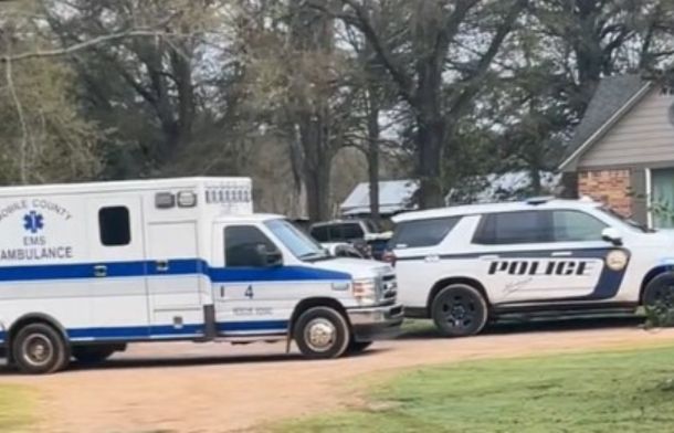 Image shows police cars and an ambulance in front of a suburban home.