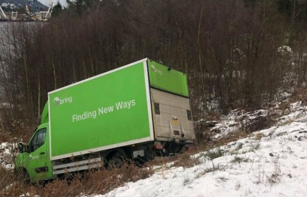 A marketing slogan on a truck says "Finding New Ways." The truck is off the road and facing down into a ravine.