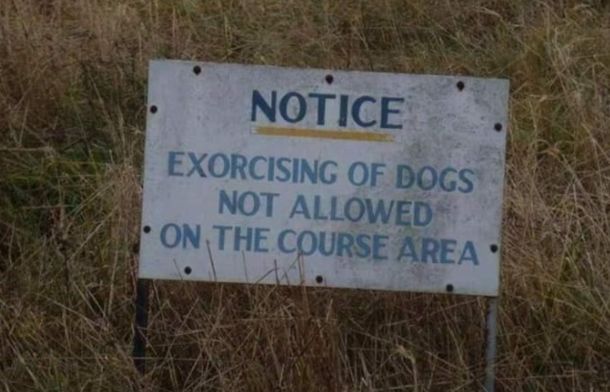 A sign fail telling people not to "exorcise" their dogs on the course area. The sign is posted in an overgrown field that does not resemble any type of course.
