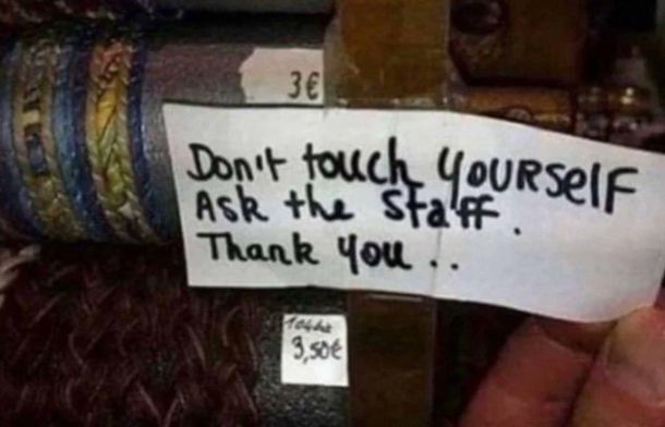 Images hows a funny and confusing sign that says "Don't touch yourself ask the staff."