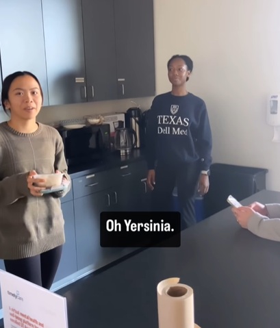 A woman in a lunch room suggests Yersinia as a baby name.