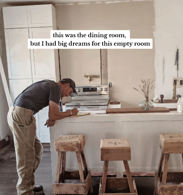 A man in a baseball cap standing in a room under construction.