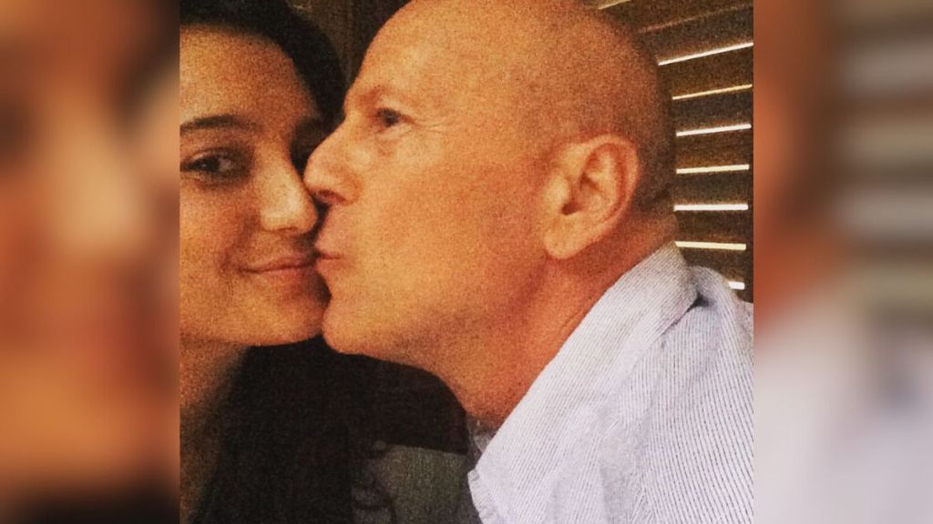 Bruce Willis kisses his wife's face.