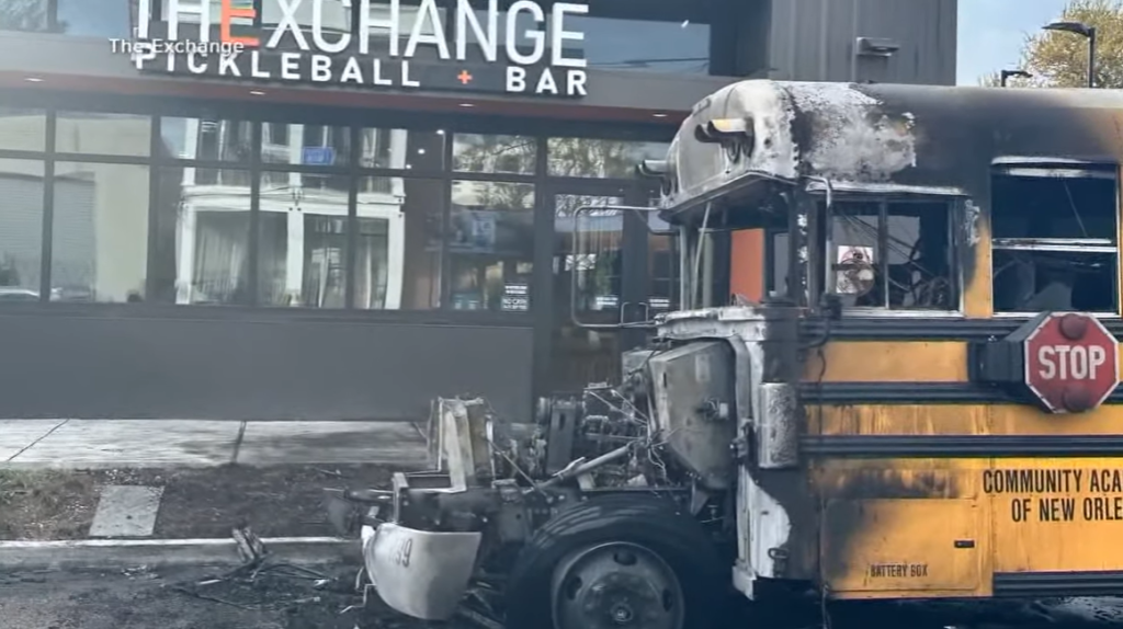 Exterior view of a bus that has been burned and largely destroyed by a fire.