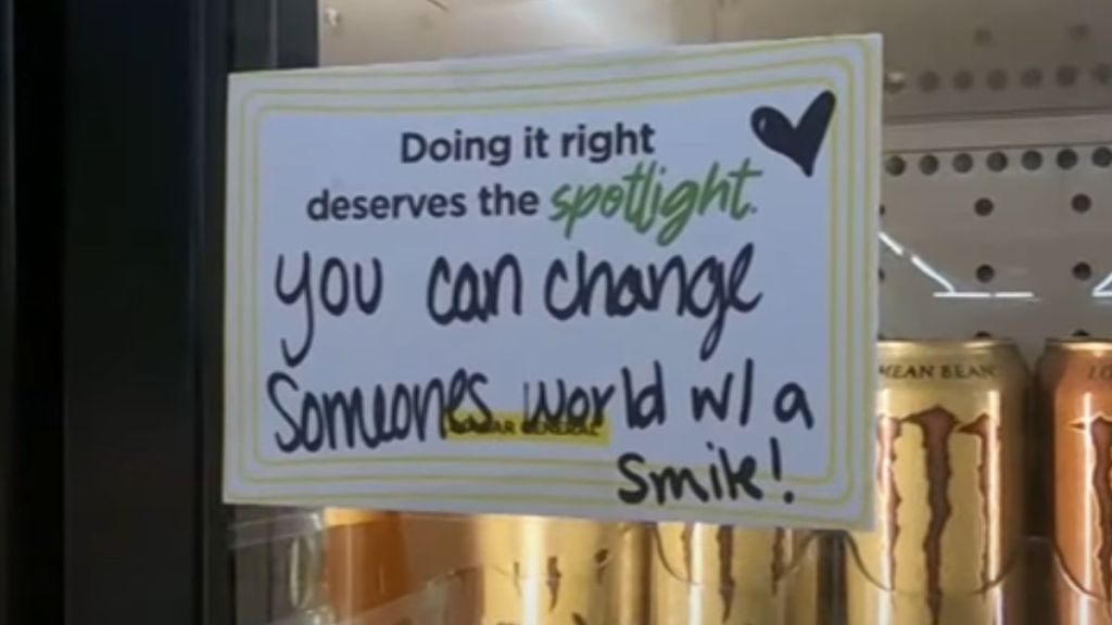 A handwritten note posted on a refrigerator inside a store.