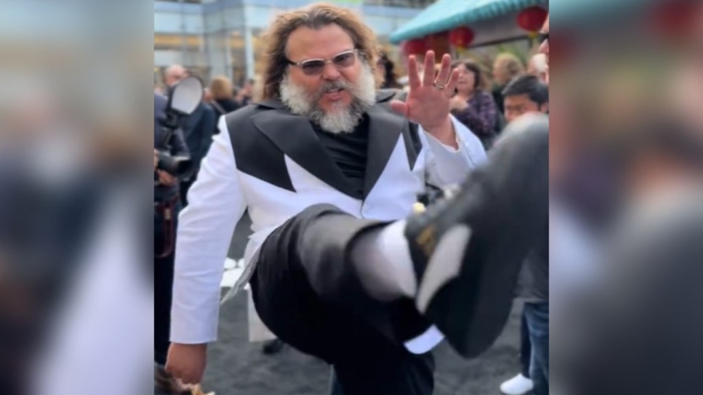 Jack Black does a kick toward the camera at the "Kung Fu Panda 4" premiere in LA.