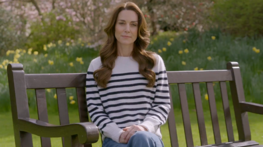 kate middleton sitting on a bench outside