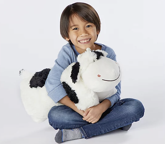 kid with cute cow stuffed animal