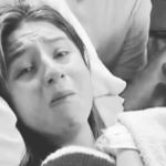 A mom is overcome with emotion as she holds her baby in the hospital.