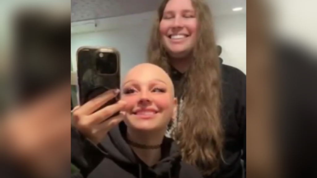 Hannah Hosking and her boyfriend, Cody Ennis smile for a photo taken in a mirror.