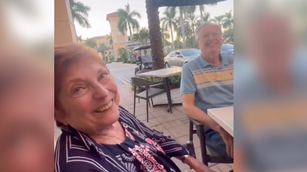 old couple smiling at a table