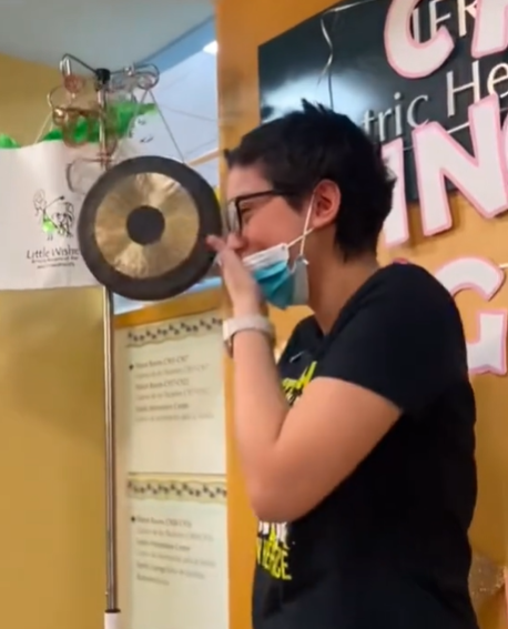 A teen patient cries while celebrating that she's cancer-free.
