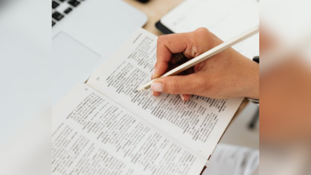 person writing in book