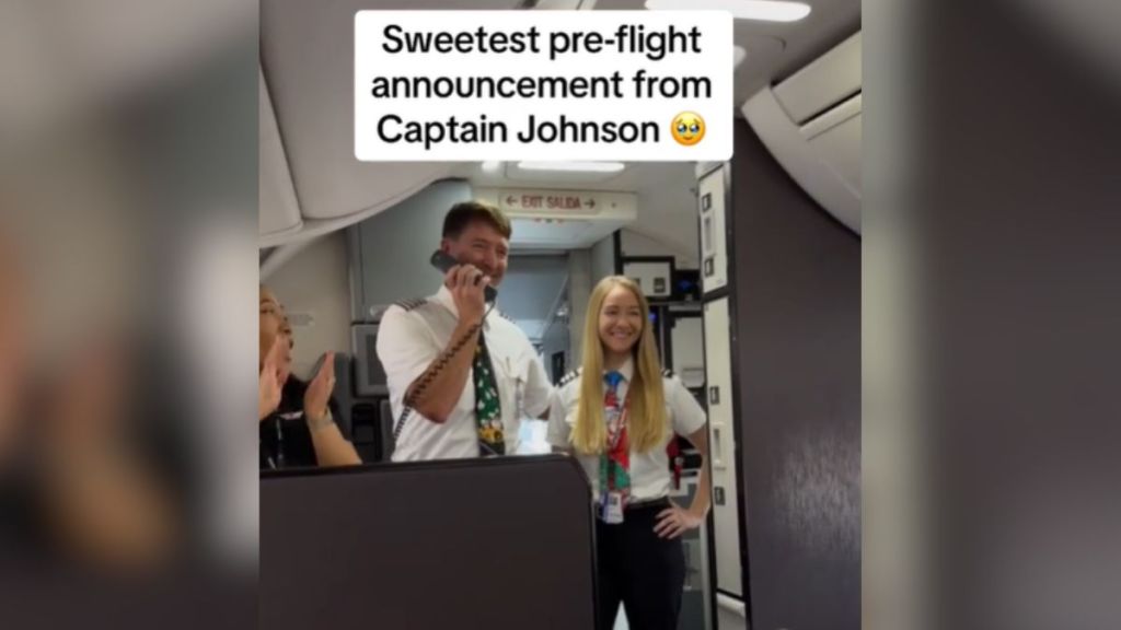 A pilot makes an announcement standing next to his first officer.