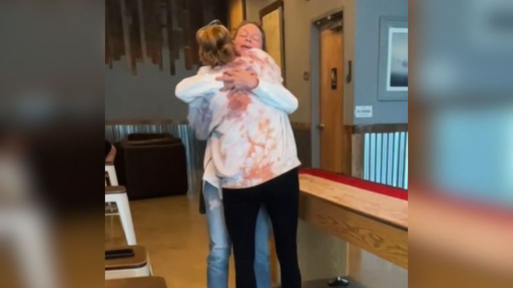 Two sisters hugging after meeting for the first time.