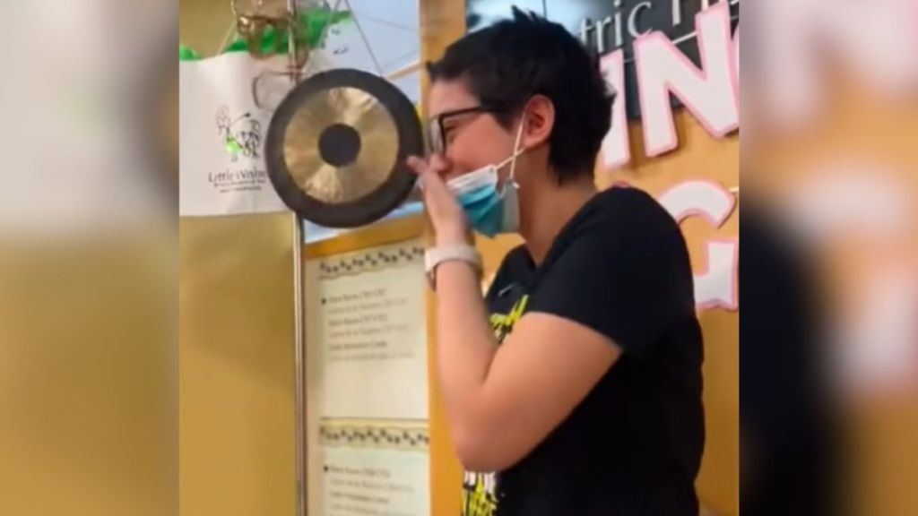 A teen patient cries while celebrating that she's cancer-free.
