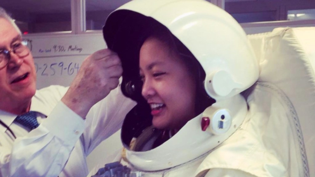 Amanda Nguyen smiles wearing an astronaut suit.